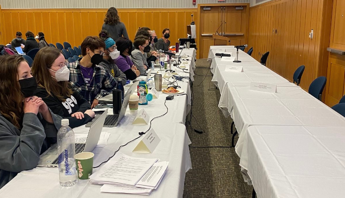 GEO members sitting at the bargaining table across from an empty table where HR is supposed to be
