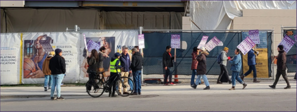 A group of picketers in front of a construction site